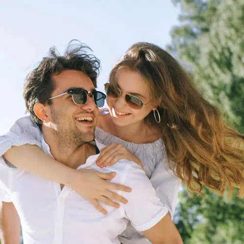 Orthodontist for Adults, couple smiling after adult braces and Invisalign treatment