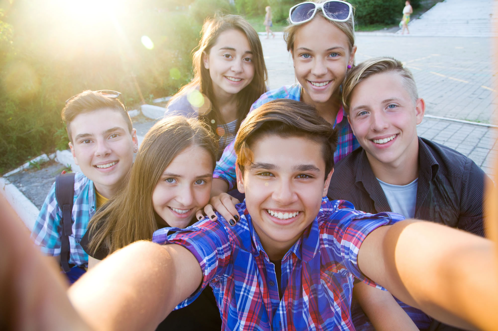Orthodontist for Teenagers. Teens smiling at camera after orthodontic treatment.